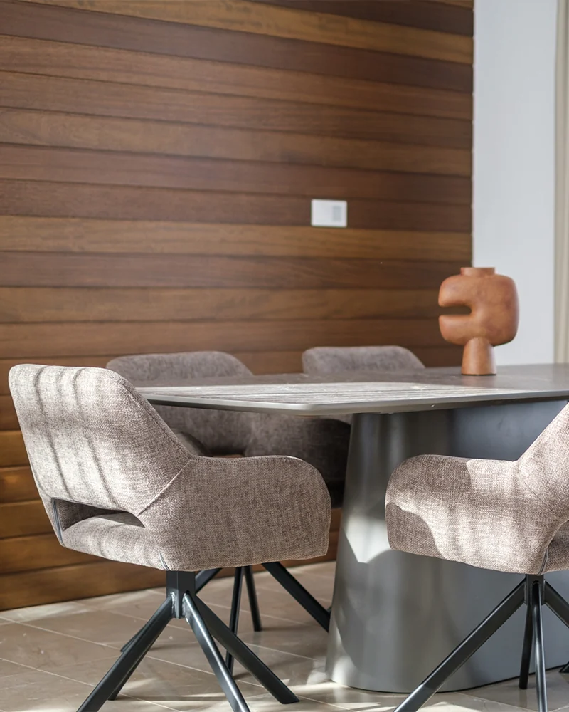 Molivin-furnished dining space with warm wood and upholstered chairs