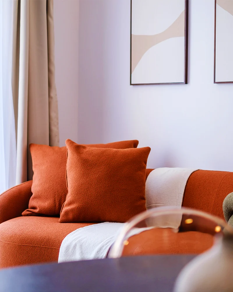 Finished Molivin living room with warm terracotta seating and coordinated artwork